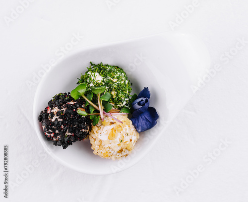 Gourmet cheese balls with herbs on elegant white dish
