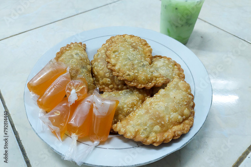 Indonesian Food - Jalangkote on a plate and Ice Melon ready to eat photo