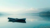 A solitary rowboat drifting lazily on a glassy lake, the only disturbance in a scene of perfect tranquility.