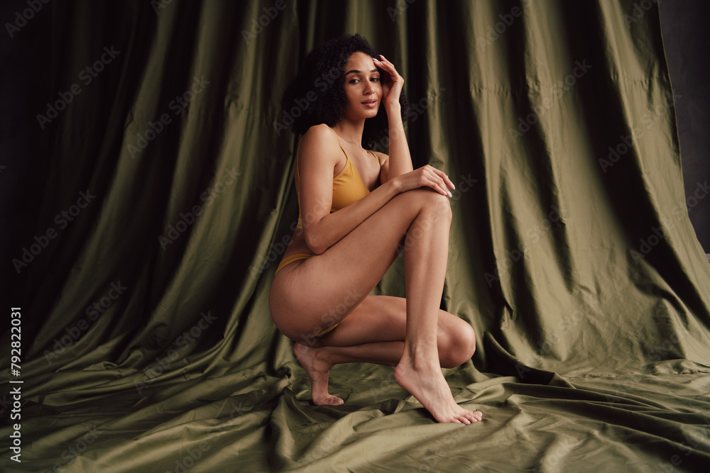 No retouch photo of gorgeous adorable girl posing in studio isolated on textile khaki color background No retouch photo of gorgeous adorable girl posing in studio isolated on textile khaki color background