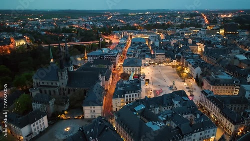 4K Aerial view of a Grand Duchy of Luxembourg , city skyline to night at Grund along Alzette river in the historical old town of Luxembourg photo