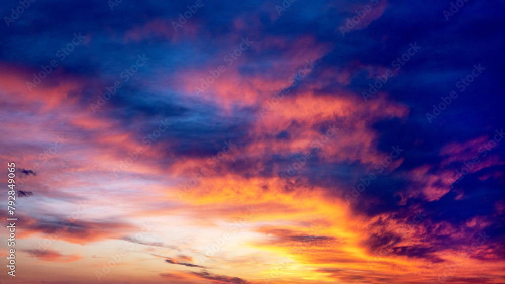 Picturesque view of orange sky with dark clouds in sunset time. Textured background of beautiful sunset. Beautiful background blur. Picturesque view of orange sky with dark clouds in sunset time. Textured background of beautiful sunset. Beautiful background blur.