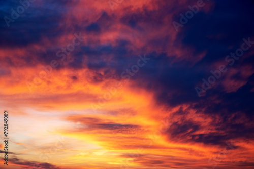 Picturesque view of orange sky with dark clouds in sunset time. Textured background of beautiful sunset. Beautiful background blur.