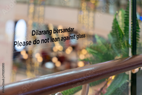 "Please Do Not Lean Against Glass" sticker on the glass railing.