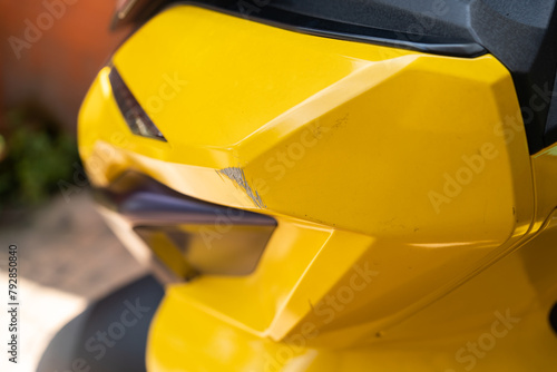 Close-up of the scratches on the yellow motorcycle.
