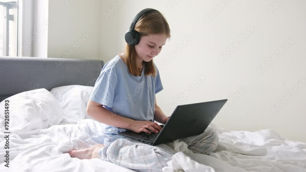 Sweet Young Girl Browsing The Internet While Sitting On A Large Bed In Her Bedroom Sweet Young Girl Browsing The Internet While Sitting On A Large Bed In Her Bedroom