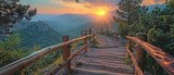 A wooden stairway with a backdrop of sunset light and views of mountains.