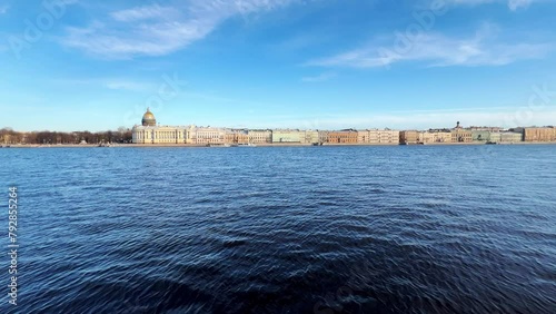 St. Petersburg, Russia - April 20, 2024. The University embankment of the Neva River. View of the sights of the city from the palace bridge. Panoramic view of the Neva River and the Palace embankment. photo