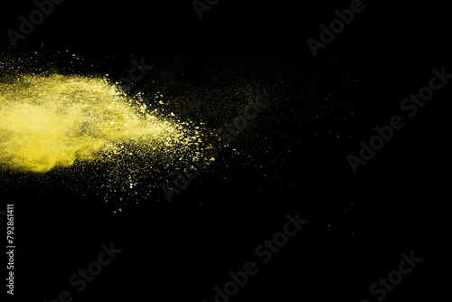 abstract powder splatted background. Freeze motion yellow powder explosion on black background