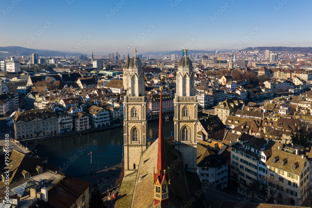 Obraz premium Zurich, Switzerland: Aerial view of Zurich old town along the Limmat river the the Grossmunster cathedral in Switzerland largest city.
