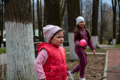 Girls playing outdoors with a ball in a park