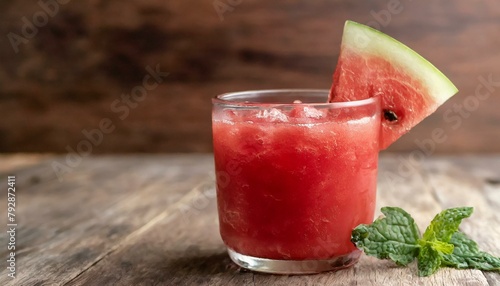 Watermelon juice on wooden background. Macro, close-up. 