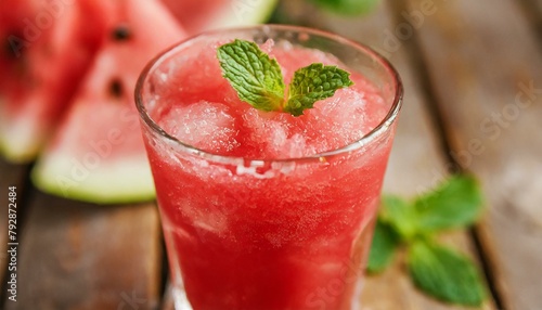 Watermelon juice on wooden background. Macro, close-up. 