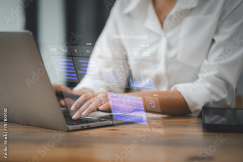 Professional analyzing complex data with a futuristic holographic display interface over a laptop, demonstrating cutting-edge technology in business analytics.