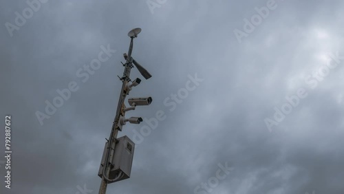 Time lapse. Wi-fi Trafic surveillance CCTV camera and cloudscape in background. Cloudy day and cloud moving fast. Electronic camera monitor the traffic and environment. Surveillance, security concept