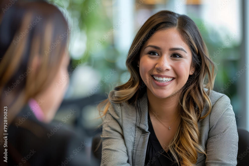 A smiling Latina businesswoman discusses job opportunities with a candidate during an interview in the office, reflecting her welcoming demeanor and competency in evaluating potential hires. A smiling Latina businesswoman discusses job opportunities with a candidate during an interview in the office, reflecting her welcoming demeanor and competency in evaluating potential hires.