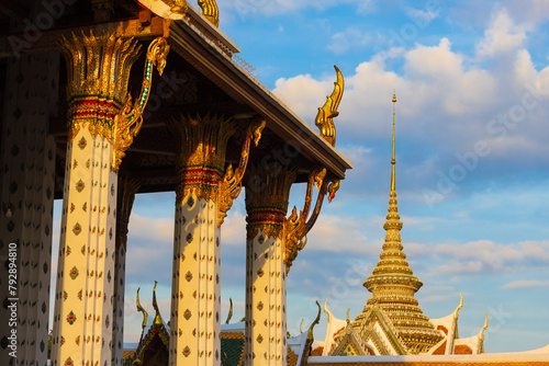 View on decorated pillars of the Ubosot or Ordination Hall from Wat Arun against great blue sky at Bangkok, Thailand. The ubosot houses the principal Buddha image of the Wat Arun. photo