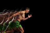 Focus and determination. Shirtless, muscular man in motion, training, running against black background with stroboscope effect. Concept of sport, active and healthy lifestyle, endurance and strength