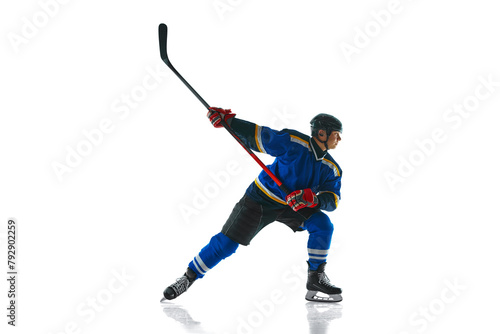 Game-ready hockey player, geared up and focused, glides with stick held high against white studio background. Concept of professional sport, competition, movement, energy, tournament, match. Ad © Lustre