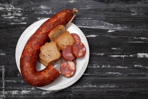 typical portuguese smoked sausage chourico on white plate photo