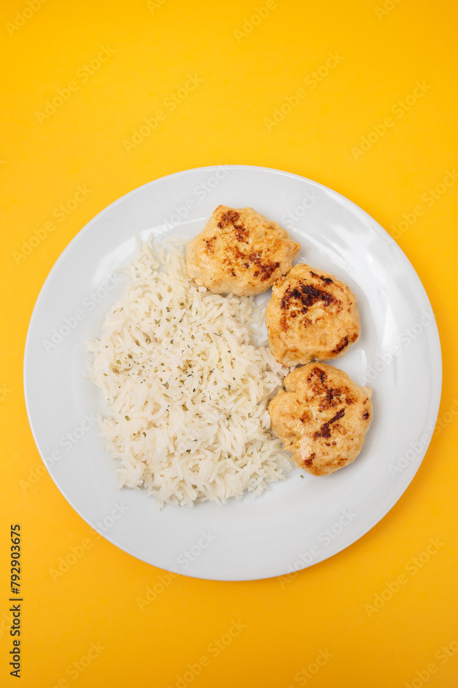 Fried chicken meatballs with boiled rice on plate Fried chicken meatballs with boiled rice on plate