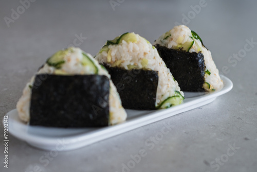 Homemade Onigiri Kyuri, rice triangle with cucumber, sesame seeds, ginger, nori seaweed (ID: 792921412)