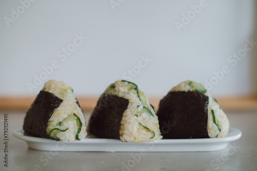 Homemade Onigiri Kyuri, rice triangle with cucumber, sesame seeds, ginger, nori seaweed (ID: 792921448)
