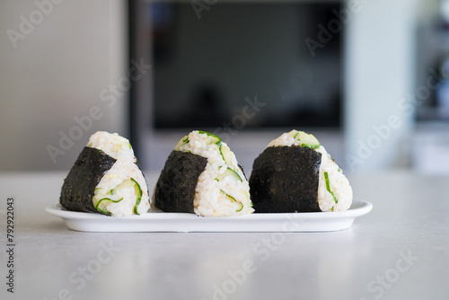 Homemade Onigiri Kyuri, rice triangle with cucumber, sesame seeds, ginger, nori seaweed (ID: 792922043)
