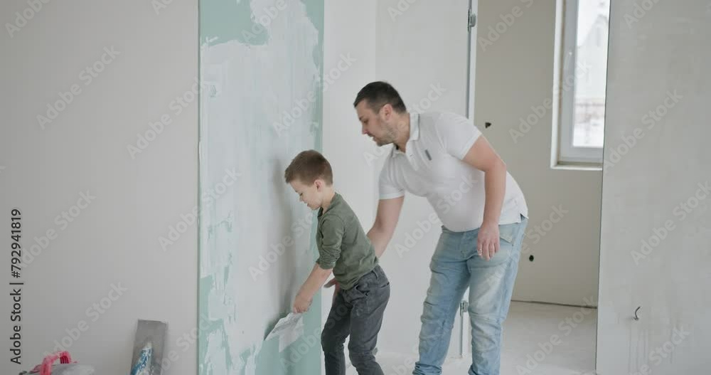 Family Bonding Over Weekend Wall Painting Project. Home improvement but also family bonding and creating memories during a do-it-yourself project in their new apartment. Family Bonding Over Weekend Wall Painting Project. Home improvement but also family bonding and creating memories during a do-it-yourself project in their new apartment.