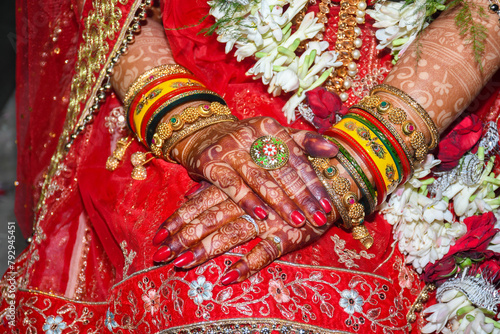 Close up of Indian Bride Hand having beautiful heena bangles and ring photo