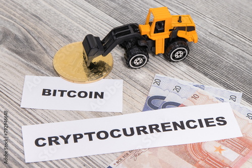 Bitcoin, miniature excavator and euro. Cryptocurrency. International network payment. Finance concept