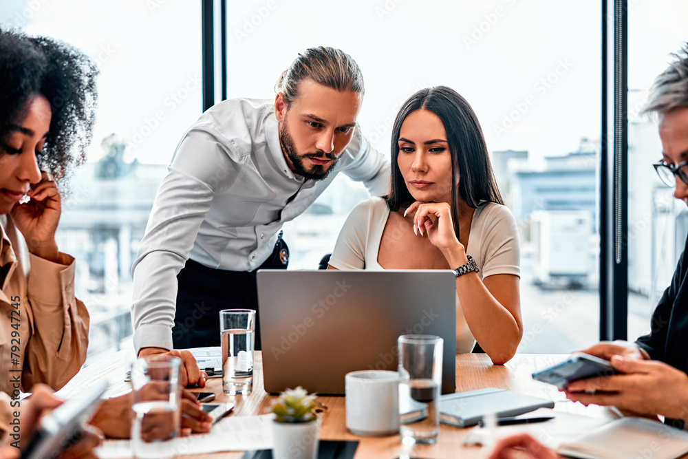 Two handsome successful business partners colleagues working in the office at the table. Business meeting and discussion. Two handsome successful business partners colleagues working in the office at the table. Business meeting and discussion.