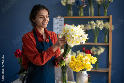 Florist shop concept. Woman holding beautiful bouquet of flowers. Florist on workplace.