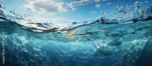 Underwater scene with blue ocean wave and sun rays.
