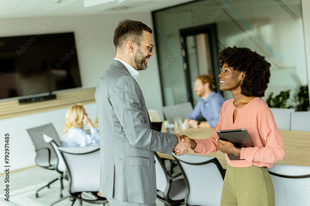 Professional handshake between colleagues in a modern office setting during daylight hours Professional handshake between colleagues in a modern office setting during daylight hours