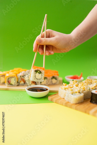 Sushi delivery. Set of rolls in a disposable box on a black background. Top view