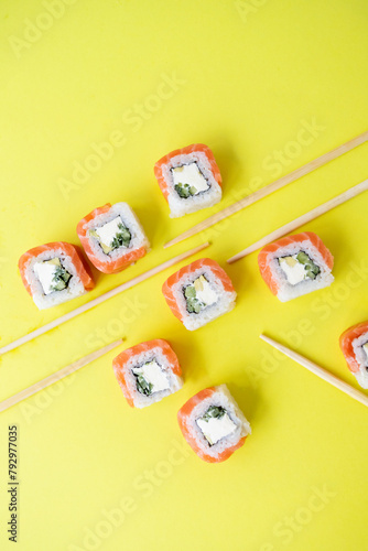 Sushi delivery. Set of rolls in a disposable box on a black background. Top view