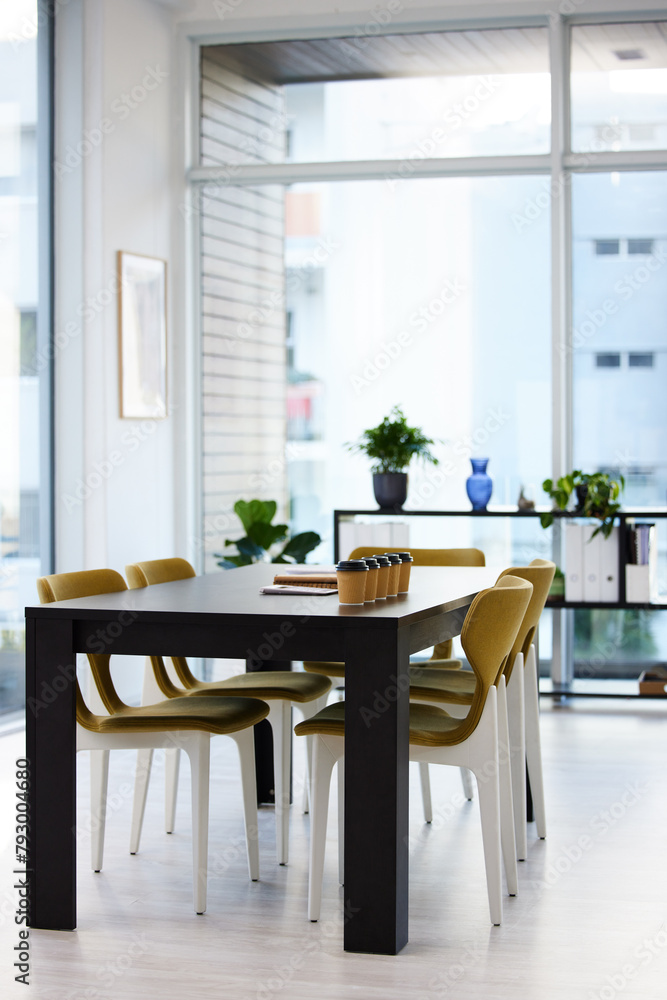 Empty office, meeting room and coffee cup on table with paperwork, seminar setup or advisory business workshop. Notebook, workspace and furniture in boardroom at consulting agency for conference