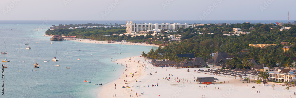 Fototapeta premium Panorama of Kendwa beach with a lot of people and a boat in the water