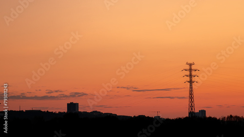 Silhouette of the city against the background of a pink summer sunset
