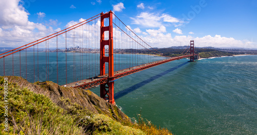 San Francisco Bay panorama with red colored Golden Gate Bridge from view point ”Battery Spencer“ on a clear sunny spring afternoon. Iconic infrastructure monument and world famous tourist attraction. photo