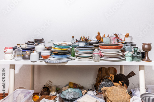 Kitchen clutter, utensils and kitchenware on a table. Concept of tidying and decluttering