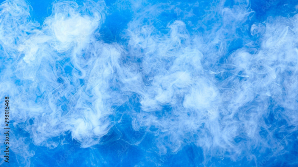 A blue sky with a thick cloud of smoke rising from the ground
