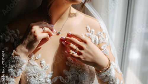 brides hands arrange chain necklace..