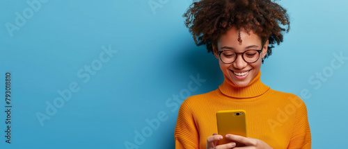 Young adult smiling happy pretty latin woman holding mobile phone looking at smartphone