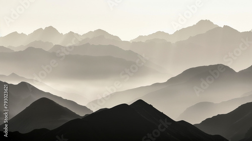 Majestic mountains rise silently from the ethereal embrace of the swirling fog, imbuing the landscape with an aura of timeless mystery and allure. photo