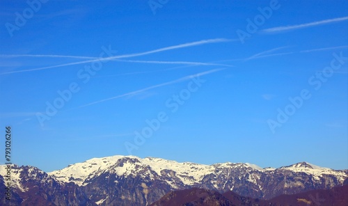 mountain panorama with white chemtrails left by the Arians or by something else According to the conspiracy theory photo