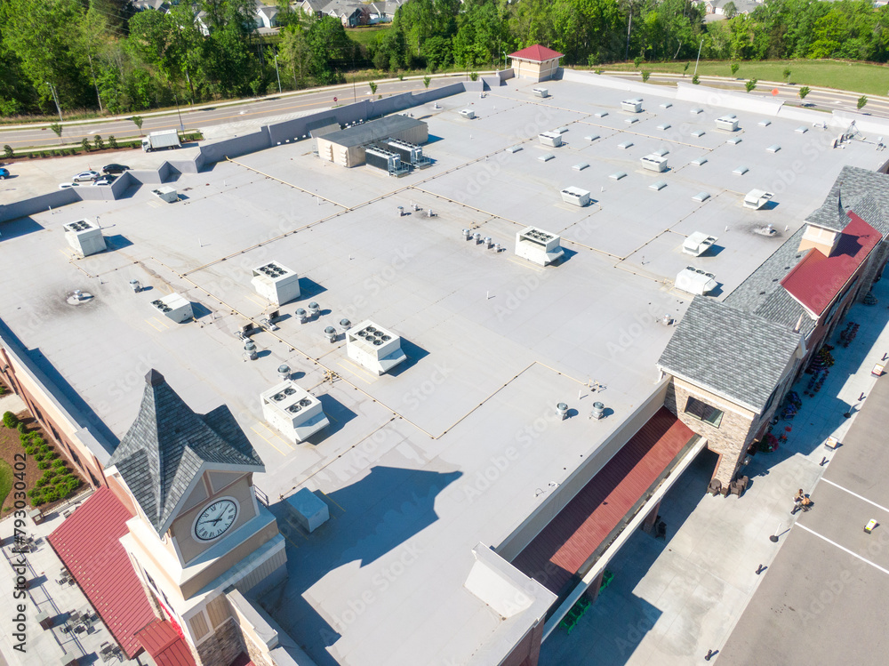 Commercial flat roof installation in progress on large industrial building