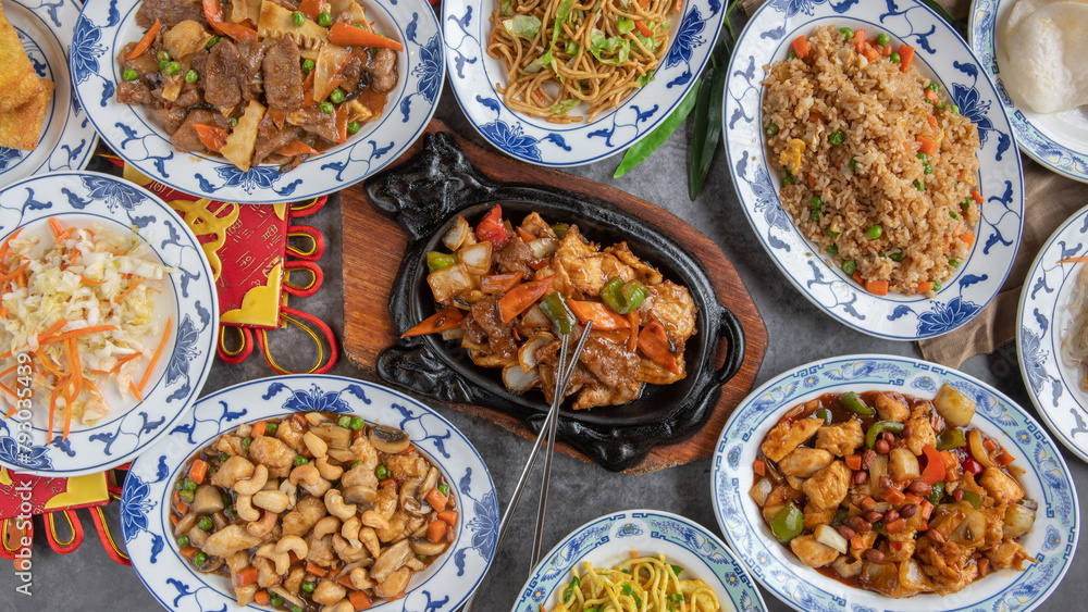 Table Full of Food: An image capturing a bountiful spread of various dishes arranged on a table, showcasing a diverse assortment of cuisines and flavors, ideal for feasts or banquets.