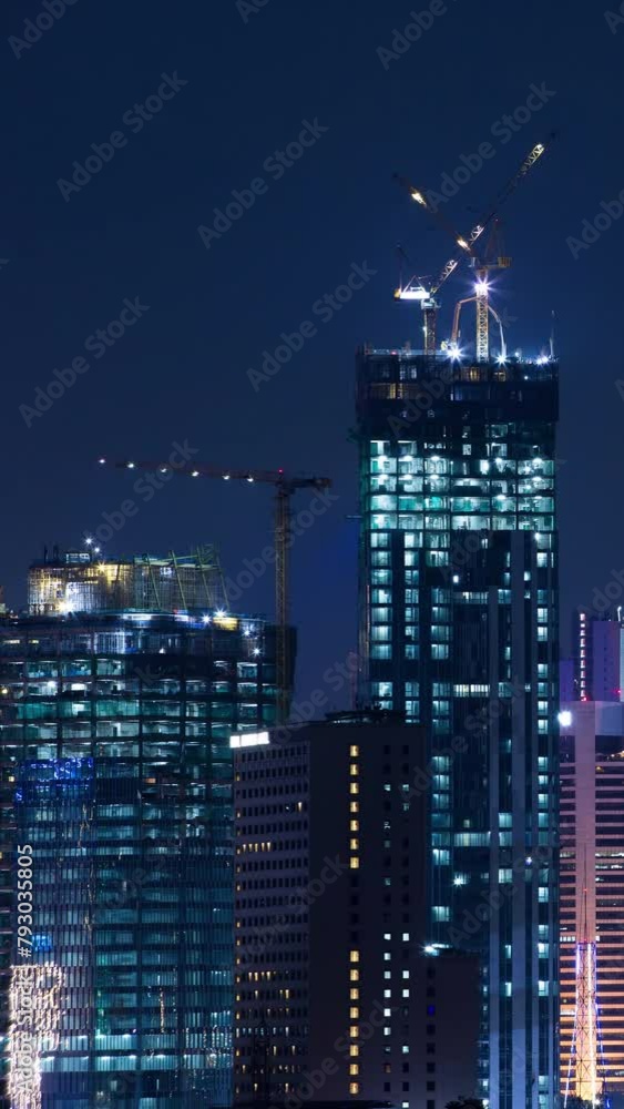 Vertical video - Construction of a new skyscraper in Jakarta business district at night Vertical video - Construction of a new skyscraper in Jakarta business district at night